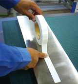 Apply the tape and press it with a finger or a roller to firmly set it in place.